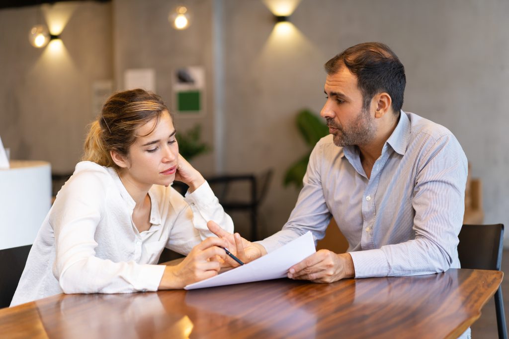 Couple discussing inheritance tax planning in Norfolk with a financial advisor.